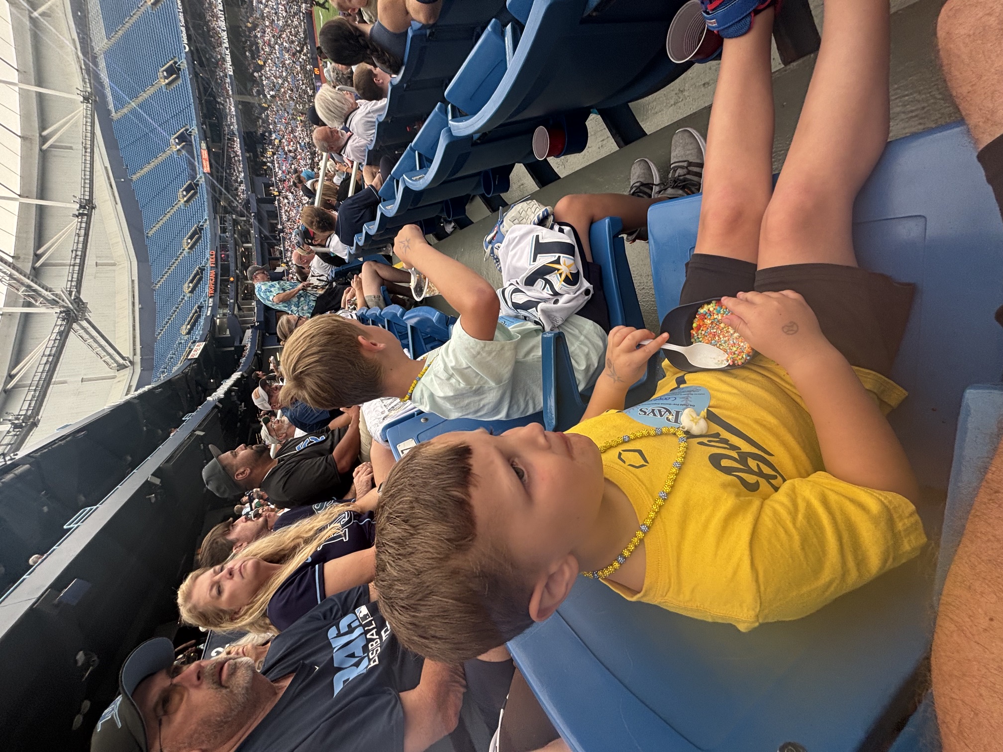 The boys settled into the seats, snacks in hand, watching the game